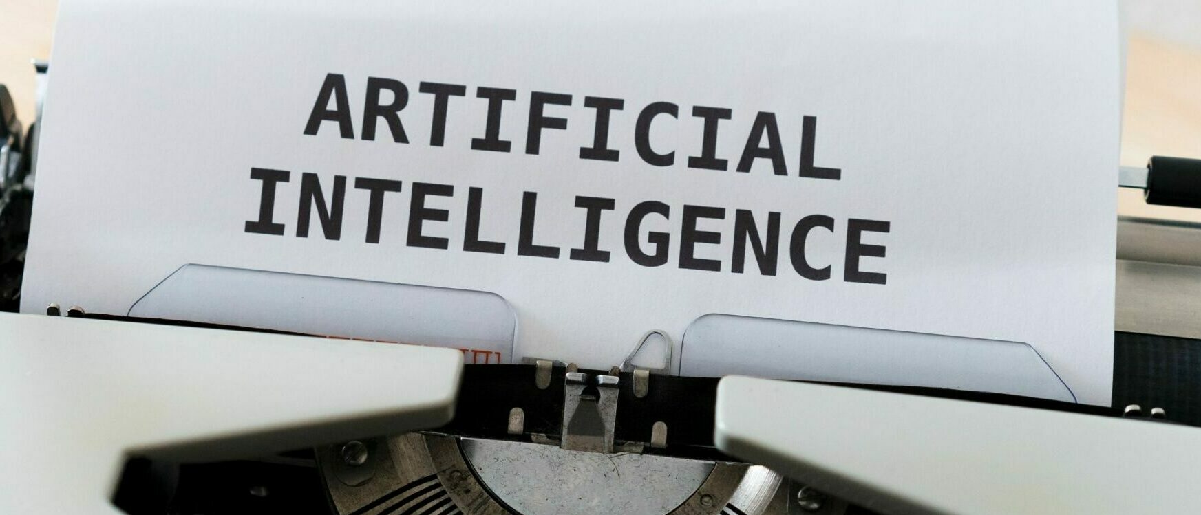 A photo of a typewriter with ARTIFICIAL INTELLIGENCE in capitals.