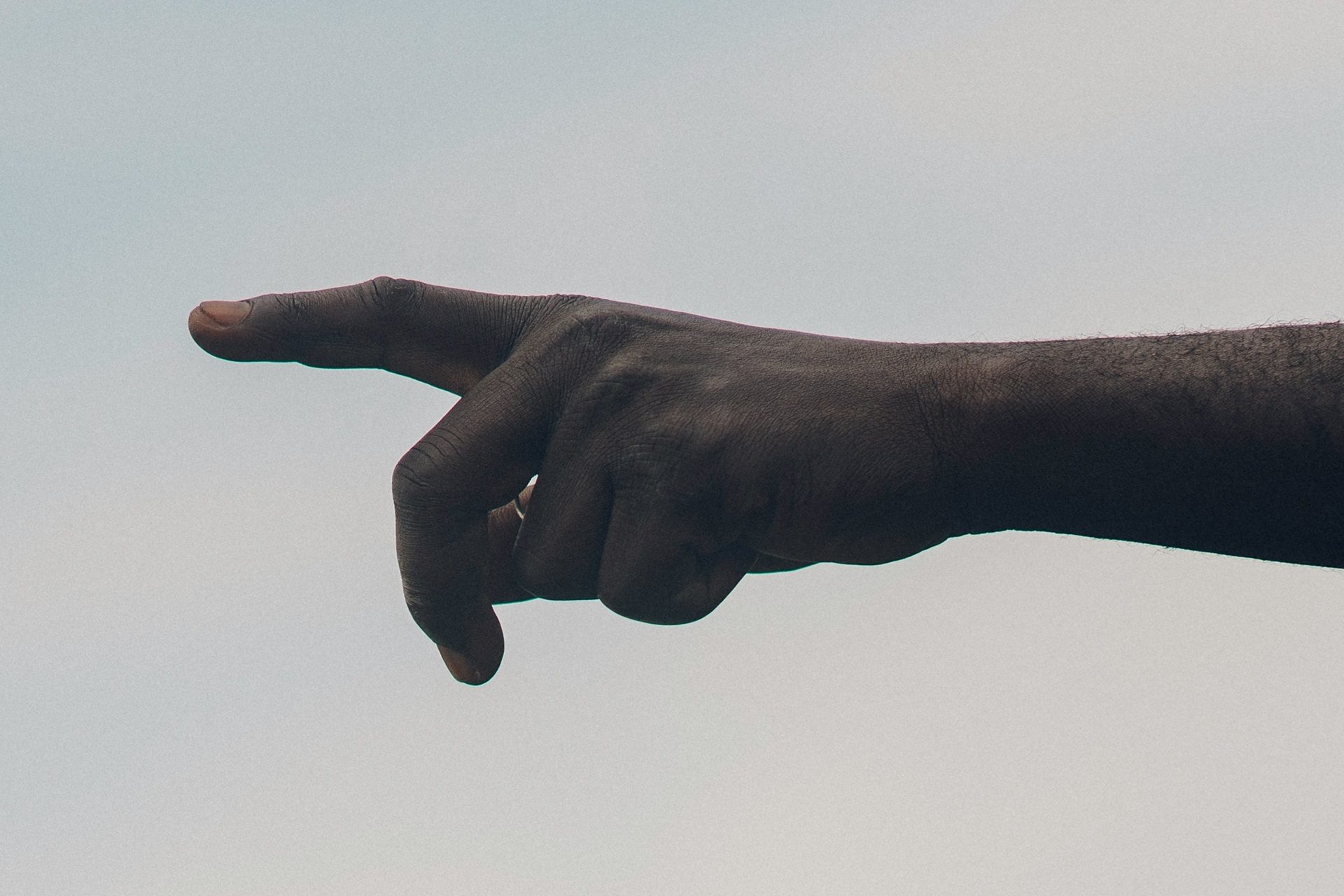 A human hand pointing to the left (Photo by Random Institute on Unsplash)