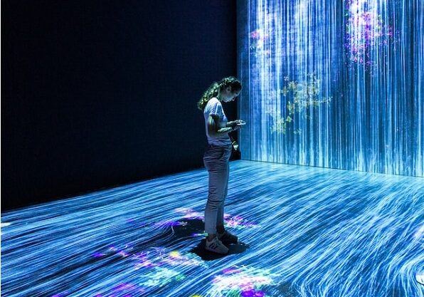 Futuristic image of woman standing in streams of data
