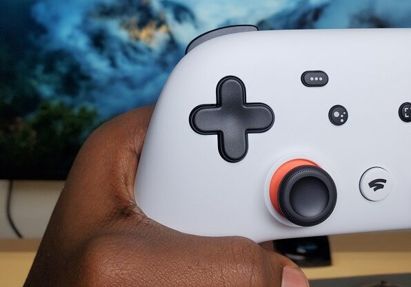 Player hand holding gaming controller.
